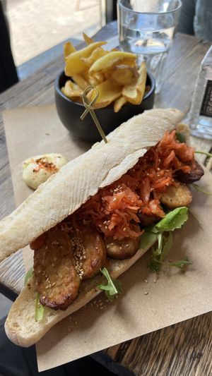 KIMCHI REUBEN (marinated tempeh, kimchi, gochumayo, greens, sourdough baguette) with RUSTIC FRIES  at SOIL Vegan Cafe - West in Amsterdam