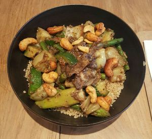 Bowl with quinoa, asparagus, green curry etc. at SOIL Vegan Cafe - West in Amsterdam