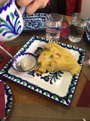 Ración de tortilla patatas con salsa tipo ajoaceite. Deliciosa!! at El Piano in Granada