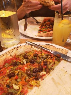 Mixed peppers, basil, capers and olives in tomato sauce, topped with chilli oil and black pepper at Paesano Pizza in Glasgow
