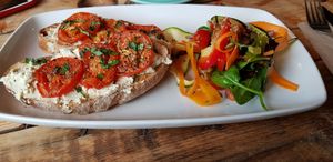 Toasted sourdough with homemade cashew cheese grilled tomatoes and basil with rainbow salad at Little Green in Newcastle Upon Tyne