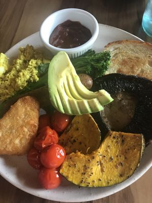 Big Breakfast with Tofu Scramble, sausage, sourdough toast, roast tomatoes, pumpkin, mushroom, fresh spinach, avocado, broccolini, and hash brown.  at Yavanna in Paddington
