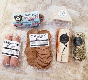 Coven's pepperoni and maple breakfast banger, Beyond Meat bratwurst sausages, and vegan nut-based cheeses from Main Vegan Deli and Green Goddess Guelph. at Coven Plant Based Marketplace in Hamilton