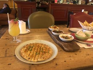 Tapas board with flatbread and dips/dishes  at Lounges - Paramo Lounge in Solihull