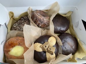 2 Boston creams, motherload (with cookie butter and cookie dough on top); blueberry old fashioned, apple fritter, creme brulee. at VEERA in Missoula