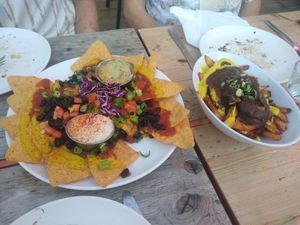 Nachos and poutine, a few bites taken already at Lola Rosa - Places des Festivals in Montreal