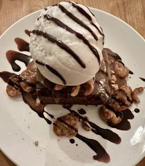 Warm brownie with peanut butter and chocolate sauce and mini pretzels.   at Lola Rosa - Places des Festivals in Montreal