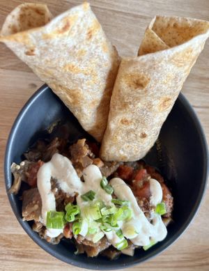 Eggplant bharta ~ Flame roasted eggplants, simmered tomatoes, garam masala spice blend served with toasted flatbread and cilantro sprouts. Yum!   at Lola Rosa - Places des Festivals in Montreal