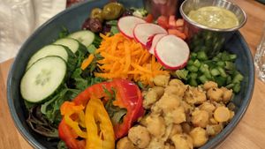 Rosa Salad -- Mixed greens, chickpeas marinated with grilled
cumin and lemon confit, tomatoes, bell peppers,
green onions, carrots, red cabbage, marinated
olives, cucumbers, ban at Lola Rosa - Places des Festivals in Montreal