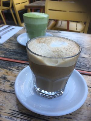 Hot coffee and matcha latte served in glasses at Lola Rosa - Places des Festivals in Montreal