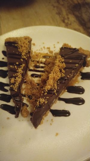Tarte choco-caramel sur croûte de pacanes et riz croustillant. at Lola Rosa - Places des Festivals in Montreal