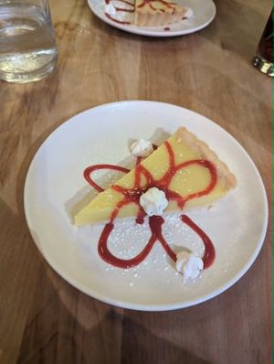 Lemon pie, this is an older picture when they used to serve it with meringue, it is now served with whipped cream  at Lola Rosa - Places des Festivals in Montreal