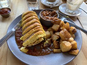 Breakfast burrito with potatoes and maple baked beans. So good! at Lola Rosa - Places des Festivals in Montreal