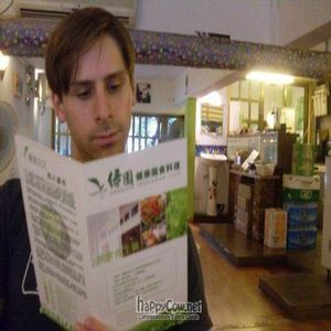 Perusing the menu at Greenland at Greenland Vegetarian Cafe in Guangzhou