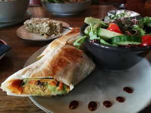 Vegan wrap with vegetables and salad as a side at Velo Cafe in Interlaken