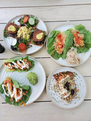 Starting from the top right and going clockwise: Thai plate, pizza, tacos, and burger platter at Rawk Star Cafe in St Petersburg