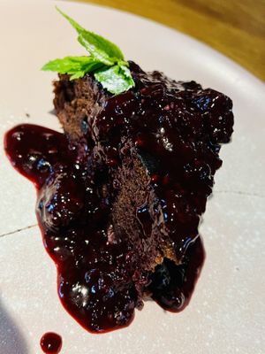Vegan chocolate cake with mixed berries sauce   at Da Vinci Italian Restaurant in Aberdeen