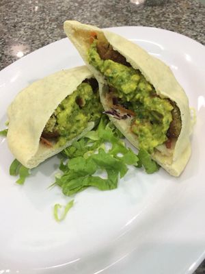 Falafel in a fresh homemade pita with guacamole and cous cous salad at Vegan Beets in Hoi An