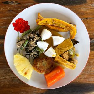 Grilled pumpkin with rosemary, ketupat (rice cakes), tofu & tempeh curry, stir fry greens with coconut, Begedil (potato patty) and fresh fruits  at LooLa Adventure Resort in 