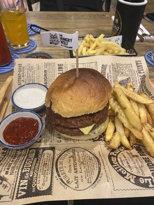Cheese burger with double omni beef patty with side of home made fries, French fries in background. Schweppes ginger ale, small Chang beer.  at The Hungry Wolf in Koh Samui