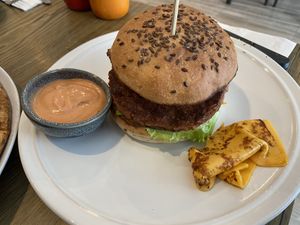 Vegan classic burger with burger sauce on the side  (came with cheese which my partner doesn’t like so that’s why it’s on the side ready for me to eat instead of him lol)  at The Hungry Wolf in Koh Samui