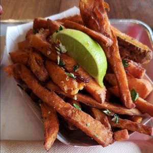 Sweet Potato fries with cilantro, garlic and lime. at Frank Gourmet Hot Dogs in Buffalo