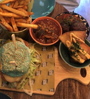 Koocha fried chicken burger (blue bun), sweet potato samosas, kotlet (mince/potato patties in a mint chilli salsa), gaymeh (aubergine & yellow split pea stew) & okra fries.   at Koocha Mezze Bar in Bristol