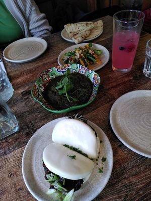 From top: plain bread, roasted broccoli, ghormeh sabzi, and bao buns at Koocha Mezze Bar in Bristol