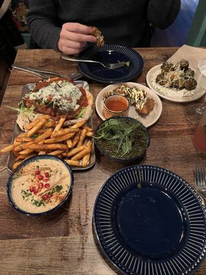 Doner kebab and fries, ghormeh sabzi, oyster mushroom wings, Parmesan sprouts and humous   at Koocha Mezze Bar in Bristol