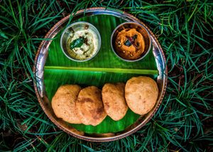 Dal Poori - Channa dal stuffed poori served with dum aloo chilly curry and seasonal accompaniment. at Go Native - Jayanagar in Bangalore