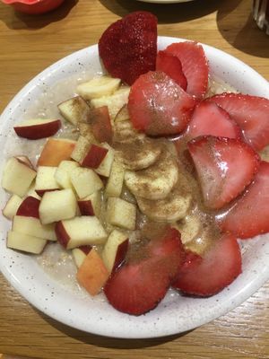 Porridge bowl with extra strawberries  at Happy Blender in Athens