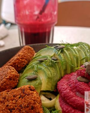 Nourishing Buddha Bowl”: “Organic red bean and quinoa ‘meatballs,’ avocado, zucchini noodles, beet hummus, chickpeas, pumpkin seeds, and beet sprouts. at Happy Blender in Athens