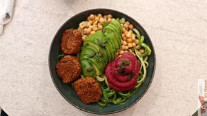 Nourishing Buddha Bowl”: “Organic red bean and quinoa ‘meatballs,’ avocado, zucchini noodles, beet hummus, chickpeas, pumpkin seeds, and beet sprouts. at Happy Blender in Athens