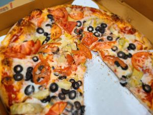 Custom pizza - tomato, artichoke, olives and vegan cheese at Troy's Italian Kitchen in Arlington