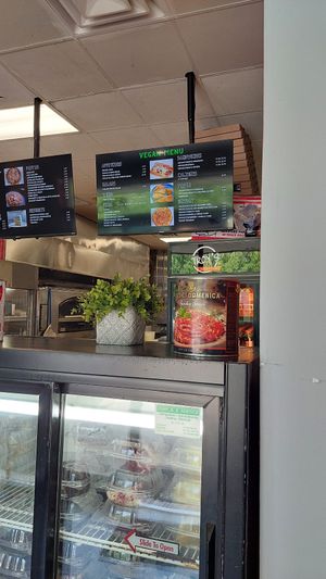 Cake fridge and vegan menu at Troy's Italian Kitchen in Arlington