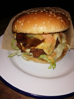 Their burger is so tasty. The sauces are so nice. It has a bakon slice added.  at The Birds in East London