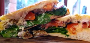 Vegan Chickin Yiros toastie. Marinated chickin in herbs and spices, baby spinach, house hummus, tomato, onion, parsley, and house garlic sauce on a toated turkish  at Good Golly Miss Polly in Burra