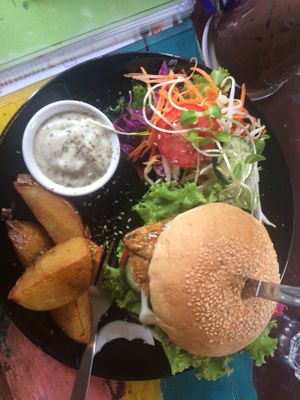 Tempeh burger comes with big potato wedges and delicious aioli (all vegan) (I hate aioli but loved this one😄 at Blossom Cafe in Pai