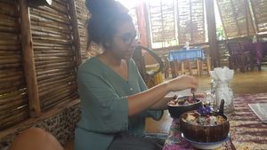 Yoana investigating the minty blues smoothie bowl at Blossom Cafe in Pai