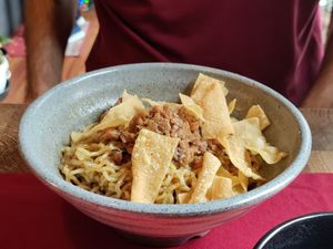 Traditional noodle dish with soy meat and crispy things at Rumah Juliet in Jakarta