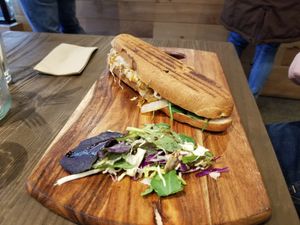 Hotdog with German sausage, mustard and caramelized onions.  at Gorilla Kitchen in Auckland