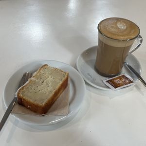 Lemon cake & Double Shot Flat White with Soy Milk   at Roots Cafe in Cascais