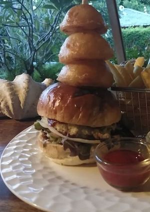 100% Homemade vegetarian burger with crispy onion rings and fries at Sea Salt Restaurant in Koh Samui
