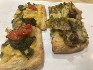 On the left: chickpea cream, chicory and tomatoes. On the right: artichokes, broccoli, fennel, taggiasche olives and tomatoes. Both delicious! at Pane e Tempesta in Rome