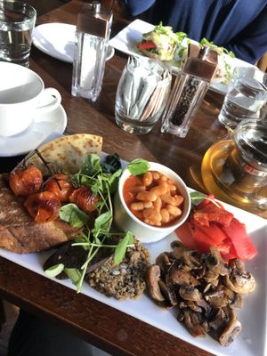 Thrive full vegan breakfast featuring roast peppers, haggis, black pudding, beans, spinach, toast, tomatoes and a tattie scone at Thrive Bar & Kitchen in Edinburgh