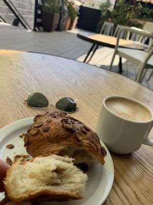 Almond croissant, filled with almond butter!! 😋 Oh and a classic latte with oat milk! What a lovely outdoor view! at Vegan Popup By XMarket in Venice