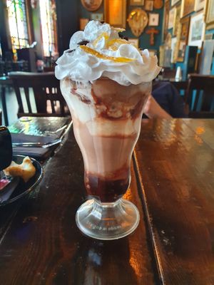 Large sundae in glass. Whipped cream, chocolate buttons and crystallised orange on top, with layers of chocolate orange and vanilla ice cream and chocolate sauce at the bottom.  at Church - Temple of Fun in Sheffield