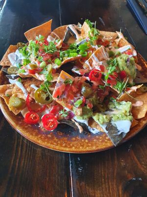 Sharing nachos - tortilla chips, chili peppers, guacamole and vegan mayo. Couldn't resist a nibble before I took the photo at Church - Temple of Fun in Sheffield