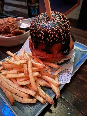 Onion ring burger and in the background mushroum crisps at Church - Temple of Fun in Sheffield