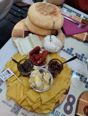 Olive paste, dried tomatoes and onion jam. More cheese and hot tasty bread at Pan8 in Bologna